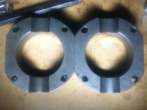 1985 Toyota Pickup/SR5 - Two metal bearing housings are shown on a wooden surface, with a tool in the background.