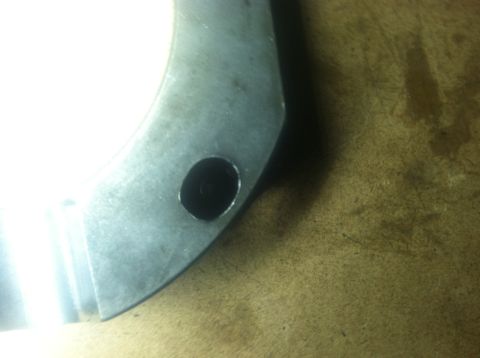 1985 Toyota Pickup/SR5 - A close-up view of a metal component, possibly an engine part, with a visible hole and a watermark.