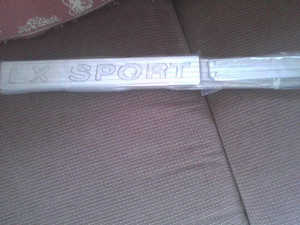 LX SPORT emblem on a car seat