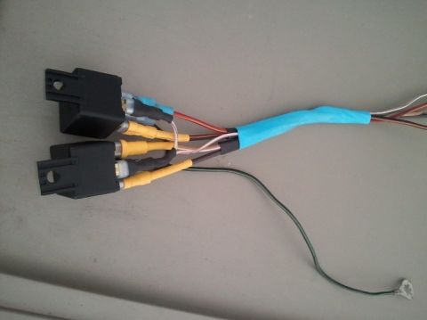 1994 Ford Bronco - A close-up view of a custom wiring harness two black connectors and multiple yellow RCA connectors.
