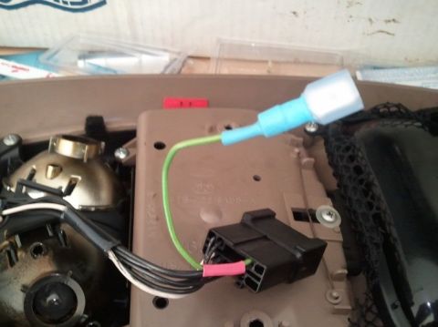 1994 Ford Bronco - Close-up of an interior wiring harness modification, showing a green wire spliced into a connector.
