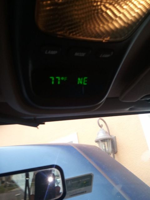 1994 Ford Bronco - Vehicle interior overhead console displays temperature and compass direction.