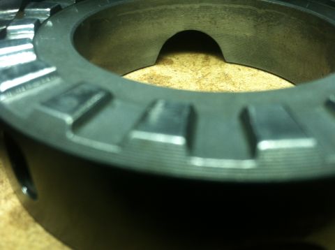 1985 Toyota Pickup/SR5 - A metal gear component is shown in close-up, with visible teeth and a central opening.