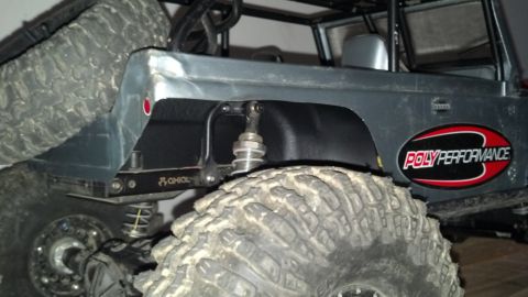 1993 Toyota 4Runner - RC rock crawler shows 'POLY PERFORMANCE' decal and large off-road tire detail.
