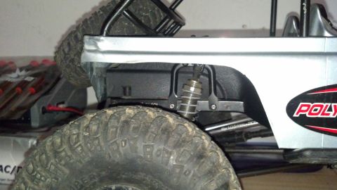 1993 Toyota 4Runner - Close-up of the rear suspension and tire on a remote-controlled rock crawler.