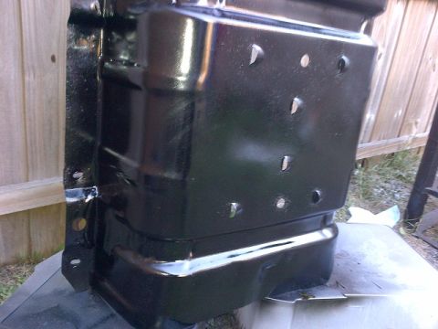 1994 Ford Bronco - A black metal component, possibly a bracket or frame piece, is shown with multiple circular holes and mounting points.