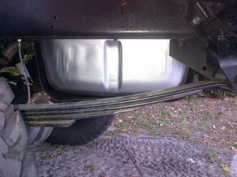 1994 Ford Bronco - This image shows the underside of a vehicle, focusing on the fuel tank and leaf spring suspension.