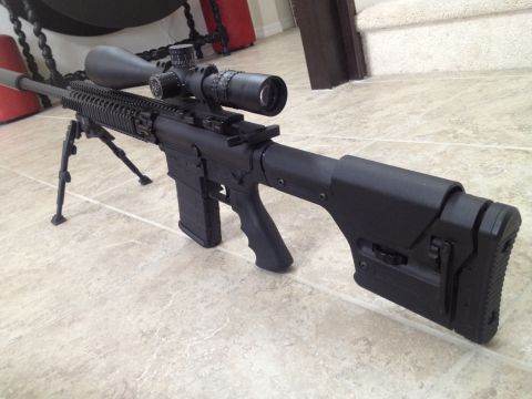 2013 Ford Mustang - A sniper rifle with a scope and bipod is displayed on a tiled floor.