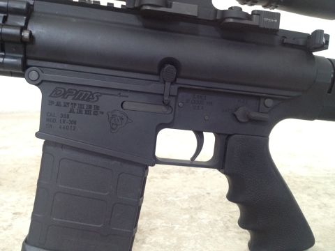 2013 Ford Mustang - This is a close-up view of a DPMS Panther Arms rifle, showing its receiver markings and magazine.