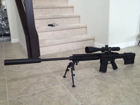 2013 Ford Mustang - A sniper rifle with a scope and bipod is displayed on a tiled floor, with stairs in the background.