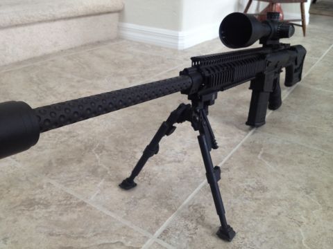 2013 Ford Mustang - A sniper rifle equipped with a scope and bipod rests on a tiled floor.