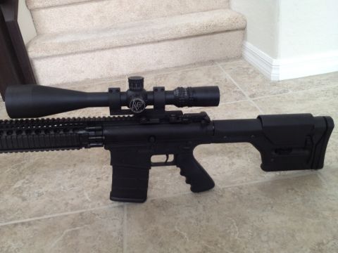 2013 Ford Mustang - A tactical rifle with a magnified scope is positioned indoors on a tiled floor.