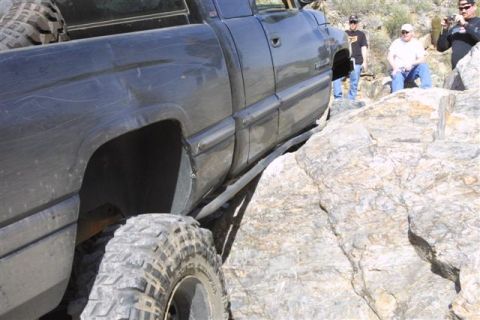 1994 Ford Bronco - Truck attempting to climb over large rocks on a trail.