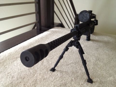 2013 Ford Mustang - A detailed view of a sniper rifle, equipped with a bipod and scope, is presented on a carpeted surface.