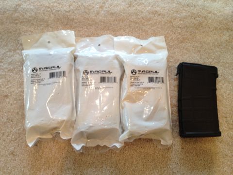 2013 Ford Mustang - Three Magpul product packages and one black Magpul PMAG magazine are laid out on a carpeted surface.