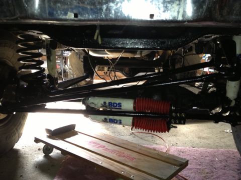 1979 Ford Bronco - The underside of a vehicle is visible, suspension parts and shock absorbers.