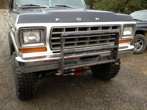 1979 Ford Bronco - Front view of a 1979 Ford Bronco, equipped with a grille guard and visible aftermarket shocks.