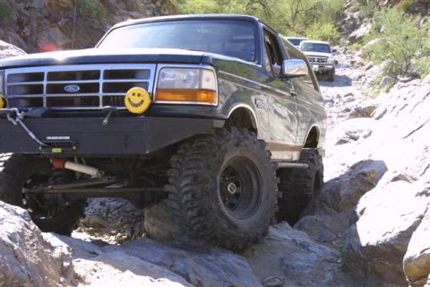 1994 Ford Bronco - Modified 1994 Ford Bronco tackling a challenging off-road course.