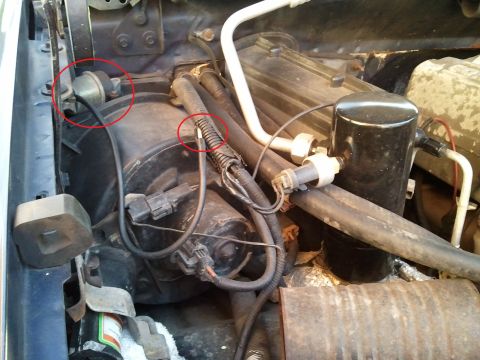 1994 Ford Bronco - Close-up of AC system parts in a vehicle's engine bay.