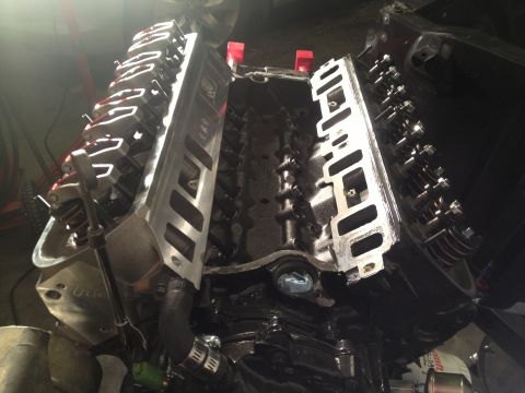 1965 Ford Mustang - Close-up view of a V8 engine's internal components, with valve covers off.
