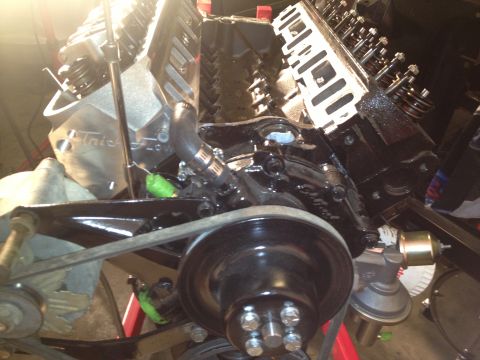1965 Ford Mustang - Close-up view of a V8 engine, showing the block, valve covers, and drive belt system.