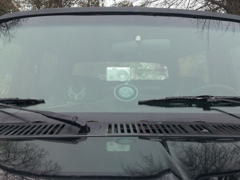 1986 Ford Bronco - Interior view of a vehicle's windshield with a camera and decal.