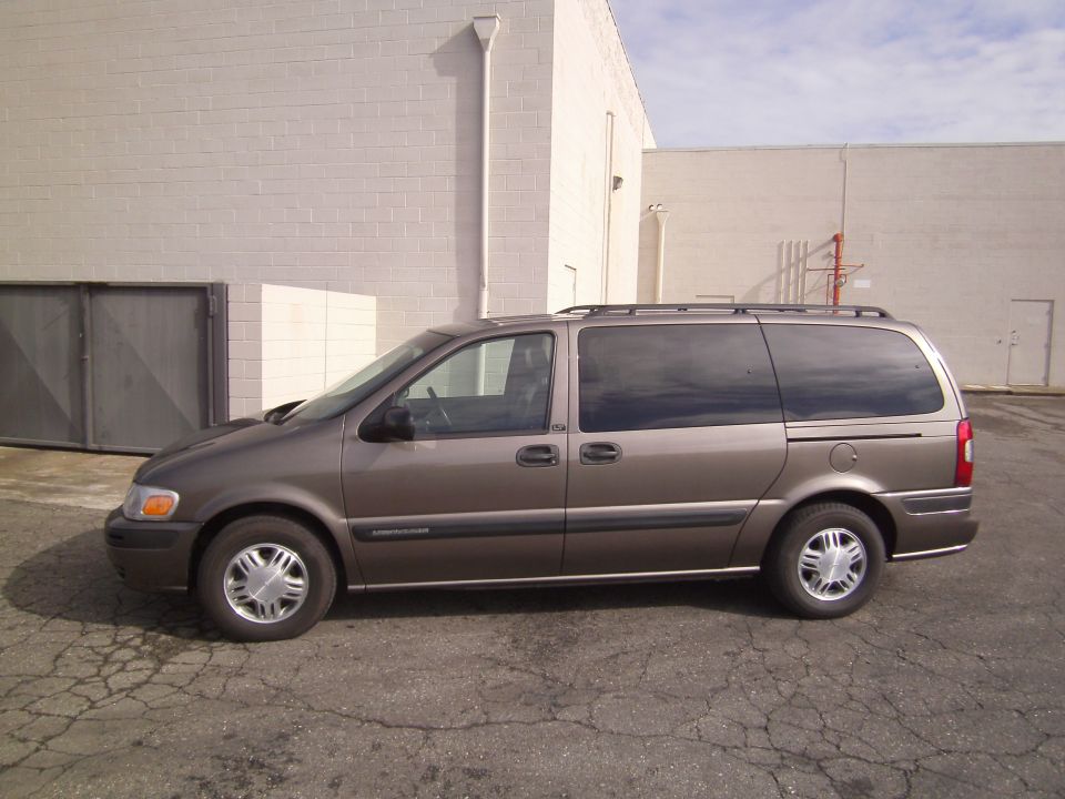 Side view of a brown 2005 Chevrolet Venture minivan parked outdoors.