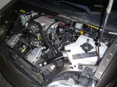 2005 Chevrolet Venture - The engine bay of a 2005 Chevrolet Venture is visible with the hood raised, revealing the engine and associated components.