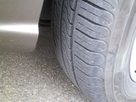 2005 Chevrolet Venture - A close-up view shows a tire and the lower portion of a vehicle's fender.