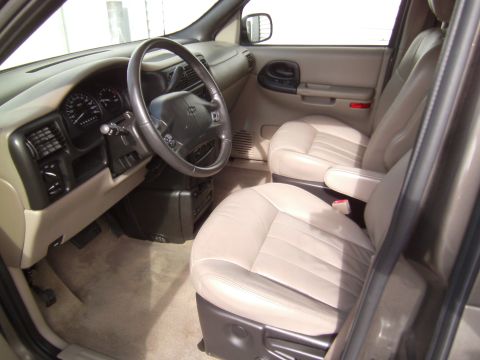 2005 Chevrolet Venture - Front interior of a 2005 Chevrolet Venture minivan, tan leather seats and a beige dashboard.