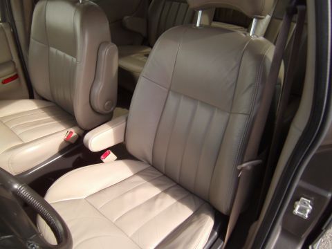 2005 Chevrolet Venture - Front leather seats and armrests visible inside a 2005 Chevrolet Venture minivan.