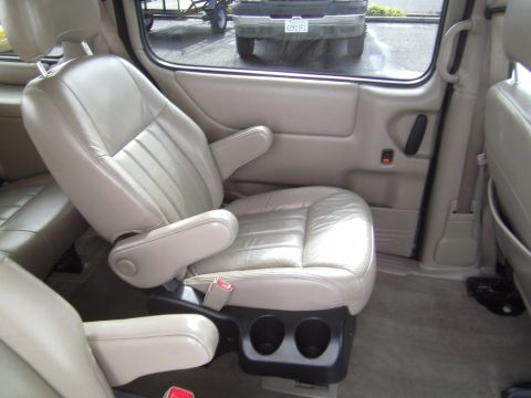 2005 Chevrolet Venture - Interior view of tan leather captain's chairs and door panel in a 2005 Chevrolet Venture.