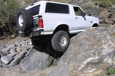1994 Ford Bronco - White 1994 Ford Bronco tackles a challenging rocky off-road course.