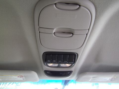 2005 Chevrolet Venture - Interior view of the overhead console in a 2005 Chevrolet Venture, storage compartments and multiple light switches.