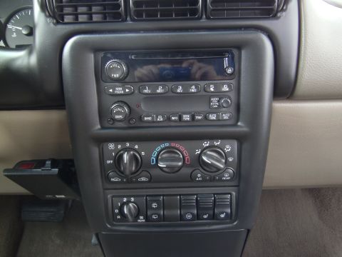 2005 Chevrolet Venture - Interior view of a car's dashboard controls, including the radio and climate settings.