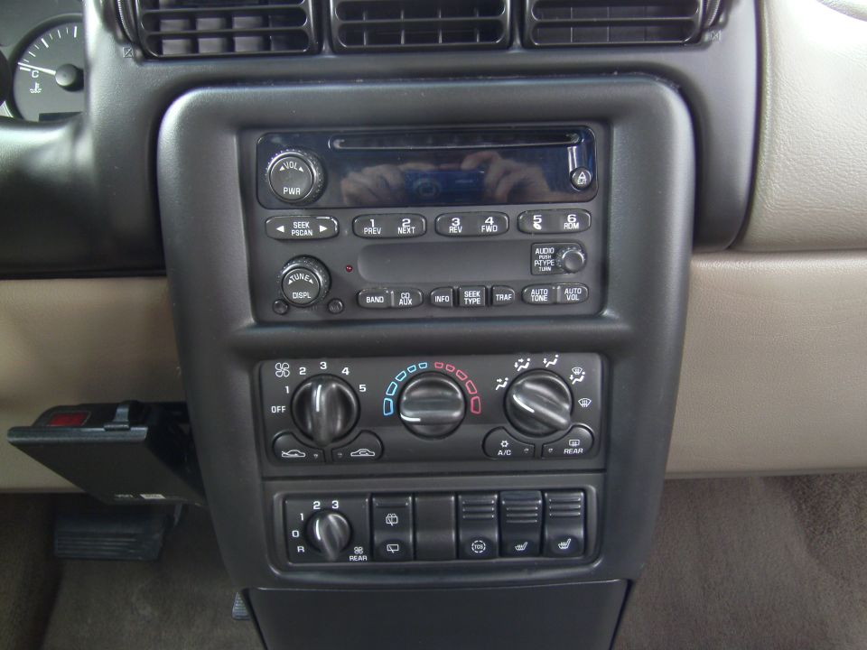 Dashboard center console with radio, climate controls, and buttons