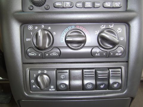 2005 Chevrolet Venture - The climate control panel features multiple knobs and buttons for adjusting various vehicle functions.