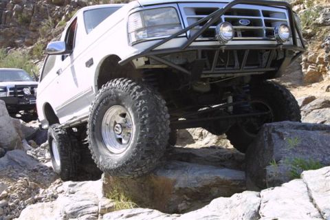1994 Ford Bronco - This 1994 Ford Bronco navigates a rocky off-road course, demonstrating its capability on challenging terrain.