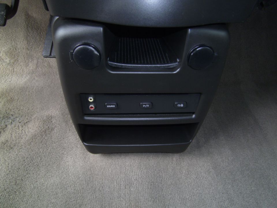 2005 Chevrolet Venture interior center console with audio inputs and storage bin