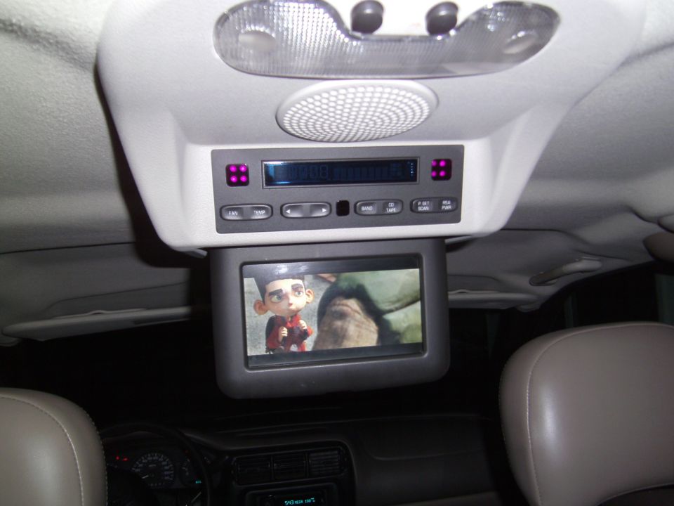 Overhead console with DVD player and screen showing cartoon character