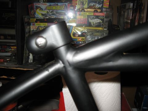 1994 Ford Bronco - A black metal frame part is shown in focus, with toy boxes in the background.
