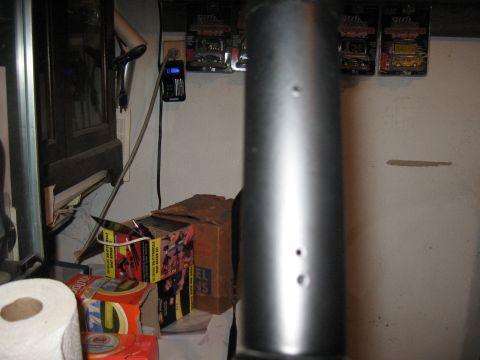1994 Ford Bronco - A blurry shot focuses on a metal pipe, obscuring the background details of a cluttered room.