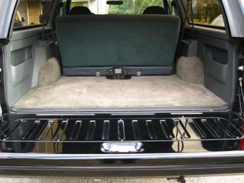 1994 Ford Bronco - Rear cargo area of a 1994 Ford Bronco, showing the folded rear seat and carpeted floor.