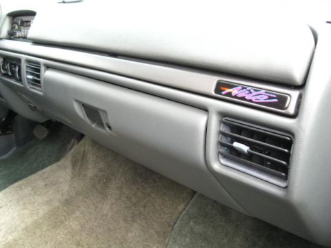 1994 Ford Bronco - The dashboard of a 1994 Ford Bronco Nite Edition shows a distinctive badge and air vents.