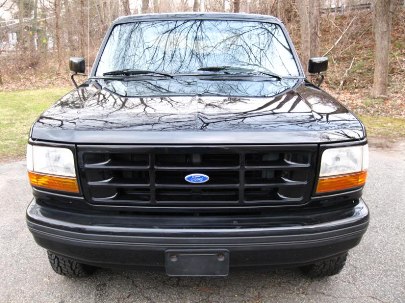 Black 1994 Ford Bronco front grille with blue Ford logo