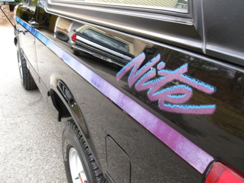 1994 Ford Bronco - The side profile of a black Ford Bronco Nite Edition shows its distinctive decal.