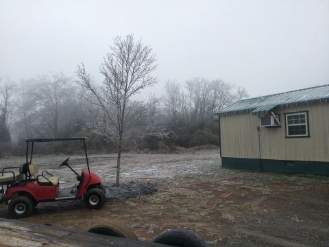 1986 Ford Bronco - A red golf cart sits beside a small building with icicles hanging from the roof.