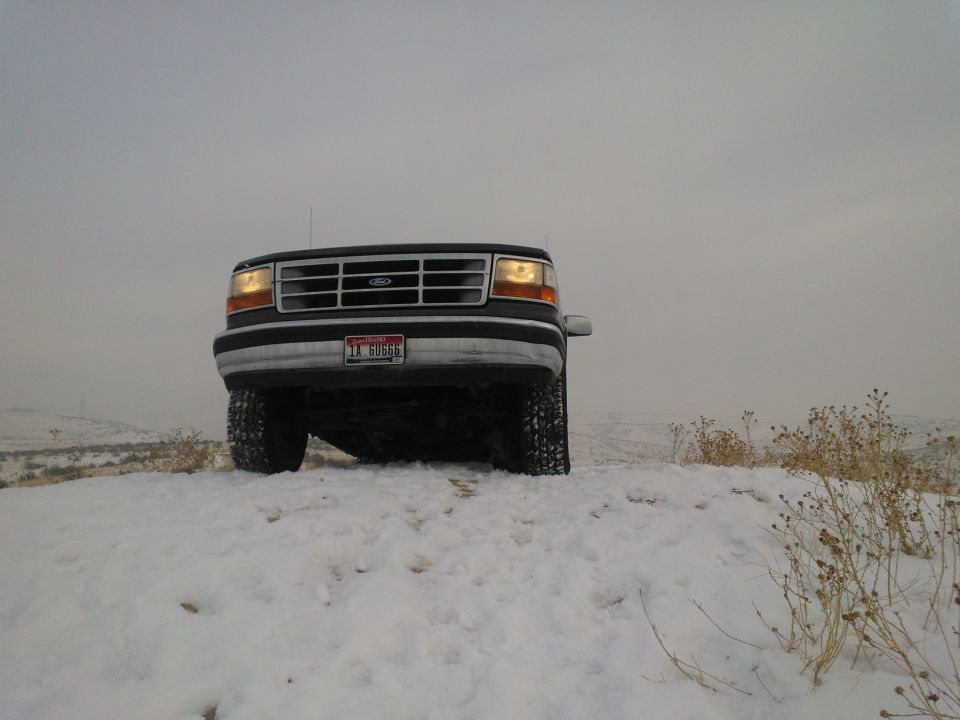 1992 Ford Bronco front view in snow, grille visible