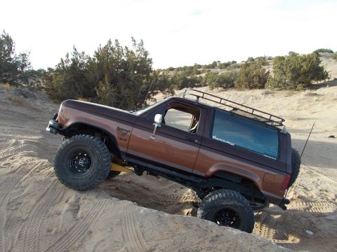 1986 Ford Bronco II - This 1986 Ford Bronco II is navigating a challenging sandy terrain, its off-road capabilities.
