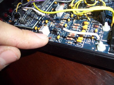 1993 Ford Probe - Electronic circuit board with components and wiring, finger touching a part. Supermotors logo visible.